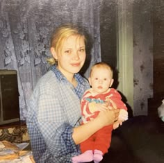 a woman holding a baby in her arms