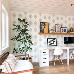 a living room filled with furniture and a tv on top of a wooden shelf next to a window