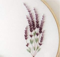 a close up of a cross stitch pattern with flowers