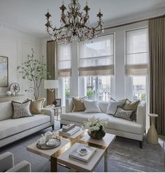 a living room filled with furniture and a chandelier