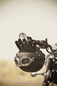 a motorcycle helmet and gloves on the handlebars