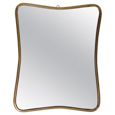 a square mirror with gold trimmings on the edges and an oval shaped frame