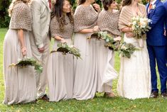 a group of people standing next to each other in front of trees and grass with flowers