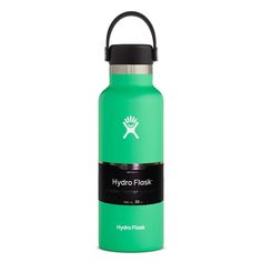 the hydro flask water bottle is green and has a black cap on it's side