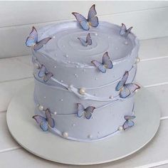 a white cake with blue butterflies on it