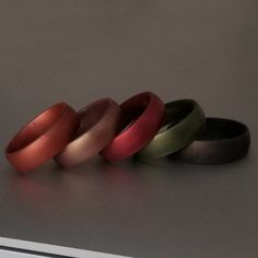 three different colored rings sitting on top of a table