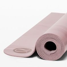 a pink yoga mat rolled up on top of each other