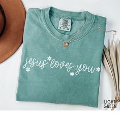 Tell the world about Jesus' love with this cute "Jesus Loves You" Comfort Colors t-shirt! It would also make a great gift! We also offer this shirt in Bella Canvas brand. Just send us a message for more information! COMFORT COLORS DETAILS: .: Soft-washed, garment-dyed fabric  .: Double-needle stitching throughout  .: 100% ring-spun cotton .: Medium fabric (6.1 oz/yd² (206.8 g/m .: Relaxed fit .: Sewn-in twill label CARE INSTRUCTIONS: .: Machine wash cold; do not bleach. Dry on low heat or lay fl God Shirts, Christian Merch, Love Like Jesus, You Mean The World To Me, Bible Verse Shirt, Christian T Shirts, Jesus Tshirts, Tell The World, Jesus Loves You