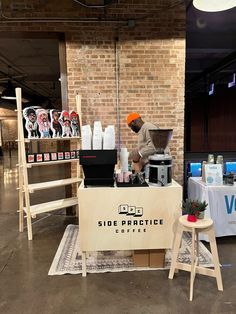 a table with two stools and a sign that says side practice coffee on it