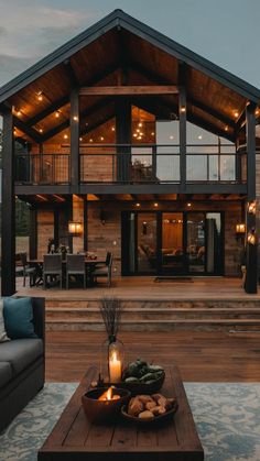 a living room with a couch and coffee table in front of a large wooden house