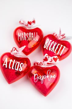 three red heart shaped candys with words on them