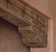 the corner of an old building with wood on it