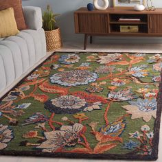 a living room area with a couch, coffee table and rugs on the floor