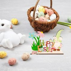 a basket filled with eggs next to an easter decoration