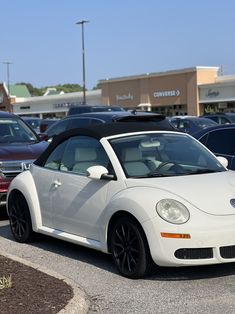 a white convertible car parked in a parking lot