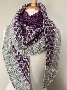 a gray and purple knitted scarf on a mannequin