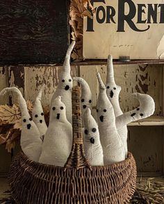 a group of white stuffed animals sitting in a basket