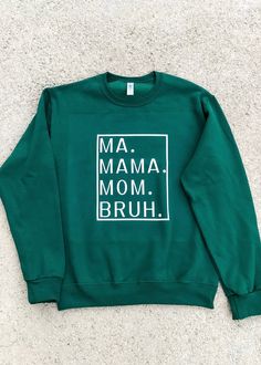 Transitioning from Ma to Mama to Mom to BRUH may seem daunting, but let's be real, being a mom is the BOMB! Show your love for the hustle of parenthood with this adorably comfy sweatshirt. Don't forget to snag some for your mommy squad and revel in the enchanted green and charming blue tones! True to Size. Unisex Fit. See size chart for details. 50% Cotton, 50% Polyester. Forest Green Sweatshirt Outfit, Casual Relaxed Fit Sweatshirt For Family, Casual Winter Sweatshirt For Family Occasions, Cotton Sweatshirt For Fall, Fall Long Sleeve Sweatshirt, Casual Sweatshirt For Mother's Day Family Gathering, Relaxed Fit Sweatshirt For Mother's Day Loungewear, Family Occasion Sweatshirt With Letter Print And Long Sleeves, Casual Sweatshirt For Mother's Day Family Event