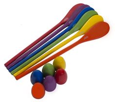 colorful plastic spoons and balls on a white background