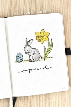 an open notebook with a drawing of a bunny and a daffodil