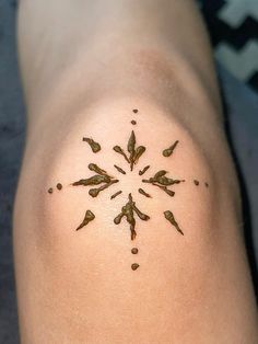 a close up of a person's leg with small tattoos on it