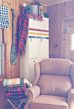 an old fashioned chair and footstool in a room with wooden paneled walls