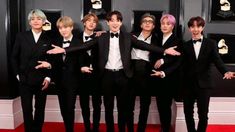 the group of boys in tuxedos are posing for a photo on the red carpet