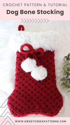 a crochet stocking with a white heart on it and the words dog bone sticking