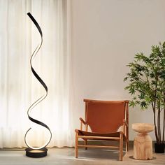 a chair sitting next to a tall metal spiral lamp in front of a curtained window