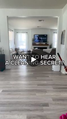 a living room with hard wood flooring and a tv on the wall above it