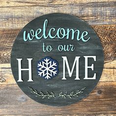 a sign that says welcome to our home on a wooden background with leaves and snowflakes