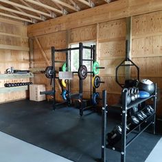 a home gym is shown in the middle of a room with wood paneled walls