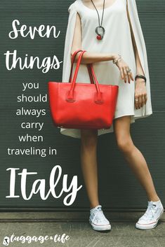 a woman holding a red bag with the words seven things you should always carry when traveling in italy