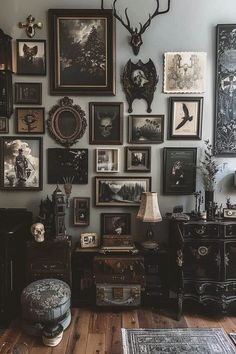 a room filled with lots of framed pictures on the wall next to a wooden floor