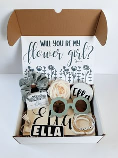 a box filled with assorted items that include sunglasses, flowers, and other things