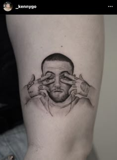 a man's face with hands covering his eyes on the side of his leg