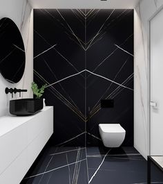 a black and white bathroom with marble flooring, walls and vanity area in the corner