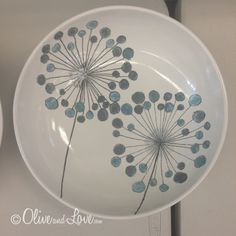 a white bowl with blue flowers painted on it and the words school auction ceramic bowls