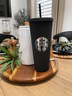 a starbucks cup sitting on top of a wooden tray