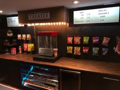 a popcorn machine sitting on top of a counter next to a shelf filled with snacks