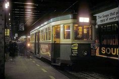 a trolley is pulling into the station at night