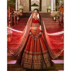 a woman in a red and gold bridal gown