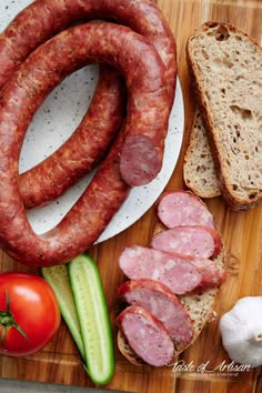 sausages, bread and vegetables on a cutting board