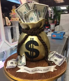 a birthday cake made to look like a money bag