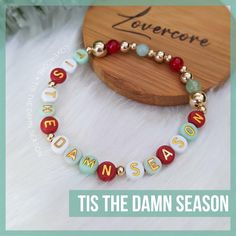 Friendship Bracelet text:  TIS THE DAMN SEASON.  Darn option available.     ✨ All gold spacers are 14k gold plated.  Acrylic beads are hand-buffed to eliminate manufacturer defects. 💖 All bracelets are made to order and will follow the color scheme selected. Bracelets measure approximately 7" unstretched and are made using high-grade elastic cord. Each bracelet is double-strung and secured with adhesive-reinforced knots to minimize the chance of breakage, however do take care to not overstretch. IF you require a size larger or smaller than the standard ~7", please leave a note with your order, I'm happy to accommodate.  Returns are not accepted, however if you have any issues with your order whatsoever, please don't hesitate to reach out so I can make it right. 💕 ABOUT LOVERCORE Handmade Elf Friendship Bracelet, Gold Beaded Christmas Bracelets, Gold Beaded Bracelets For Christmas, Handmade Gold Beaded Bracelets For Holidays, Handmade Gold Beaded Bracelets For Christmas, Christmas Seed Bead Bracelets, Christmas Bead Bracelets, Christmas Bracelet Ideas, Tis The Damn Season