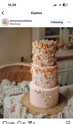 a three tiered wedding cake with flowers on the top and bottom is displayed in an instagram