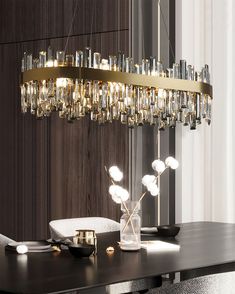 a modern chandelier hanging over a dining room table