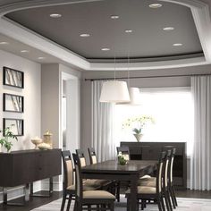 a dining room table and chairs in front of a large window with white drapes