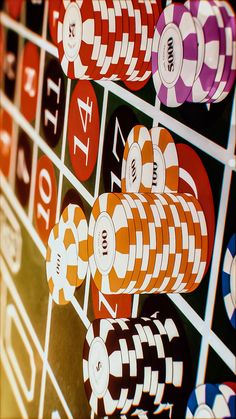 several colorful casino chips are arranged on the wall