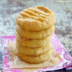 a stack of cookies sitting on top of a pink napkin